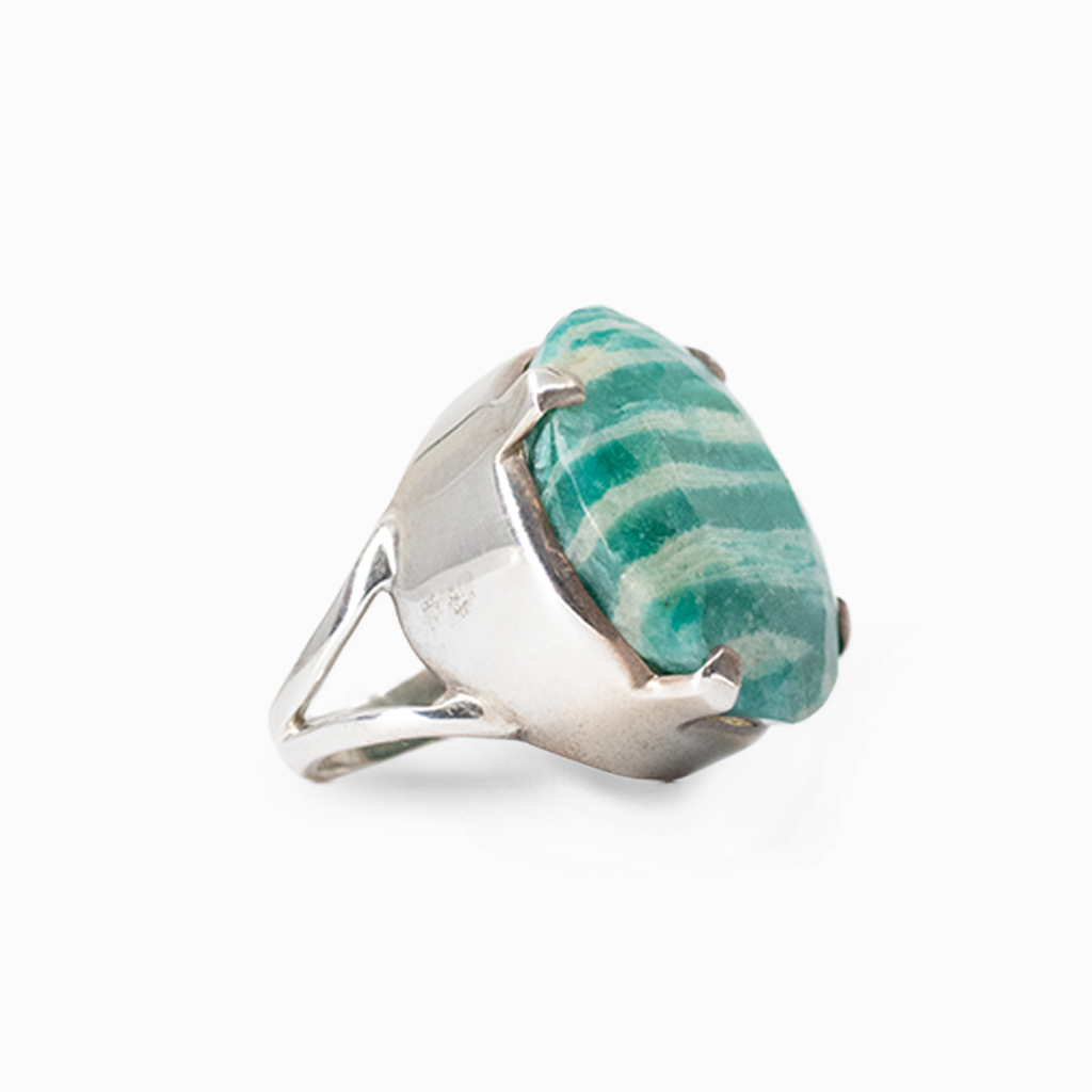 Round faceted turquoise-green Amazonite with natural cream banding in a sterling silver prong setting.