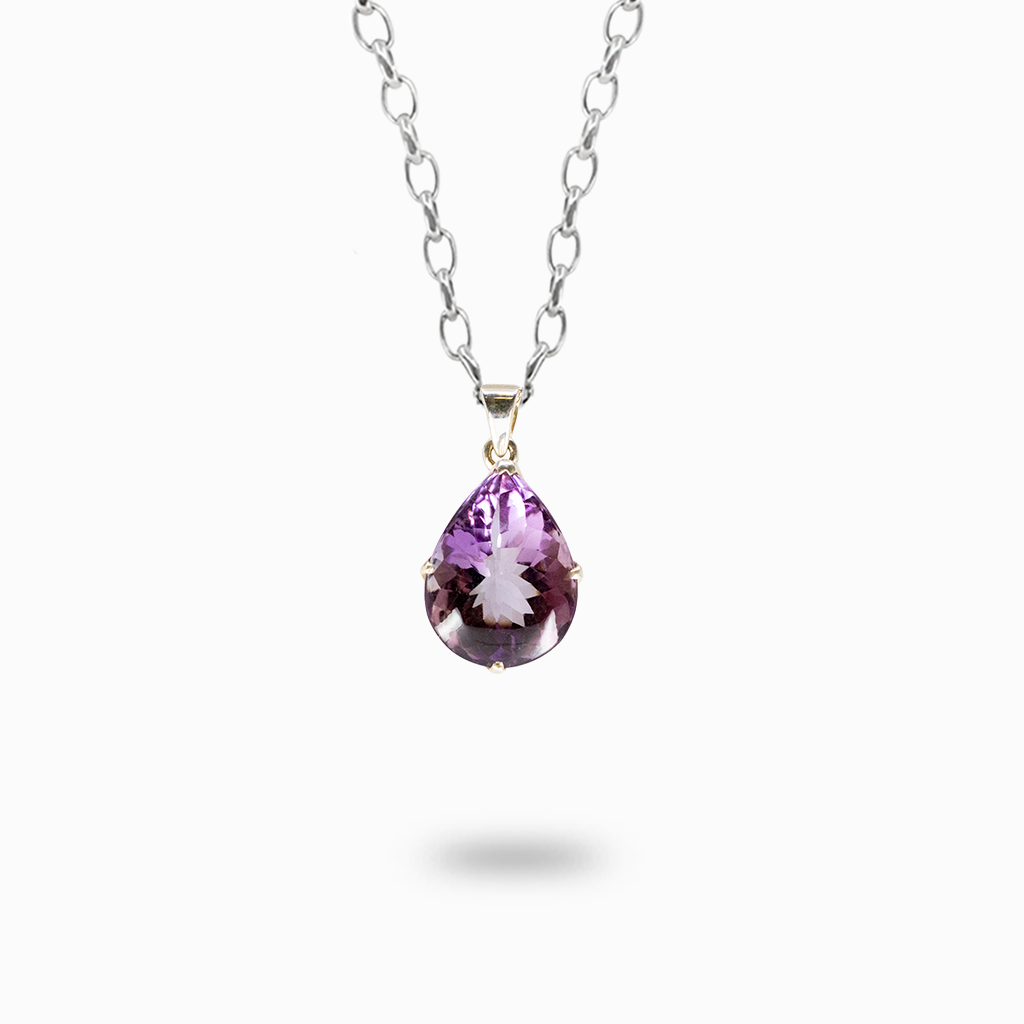 Faceted pear-shaped purple Amethyst pendant necklace in a polished sterling silver prong setting.