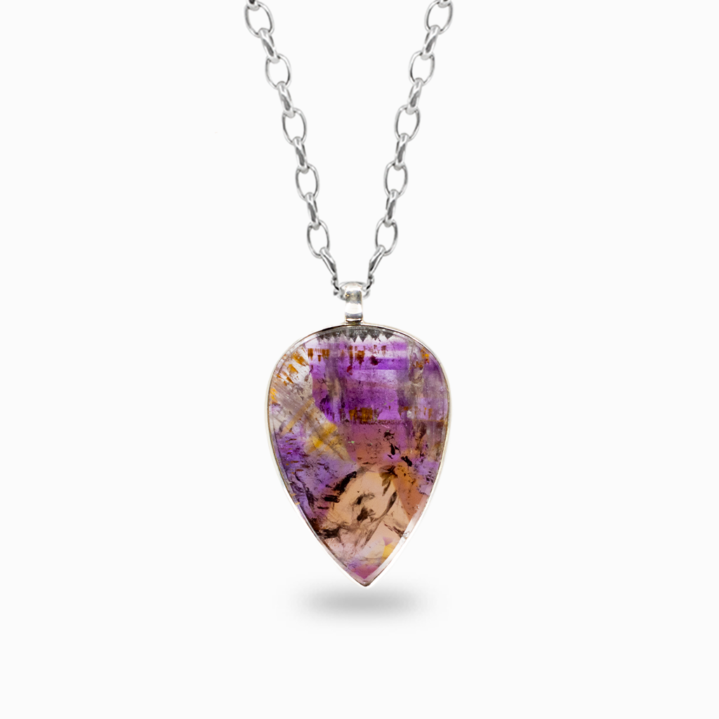 Teardrop Cacoxenite pendant necklace featuring translucent purple, golden, and smoky inclusions in a sterling silver bezel setting.