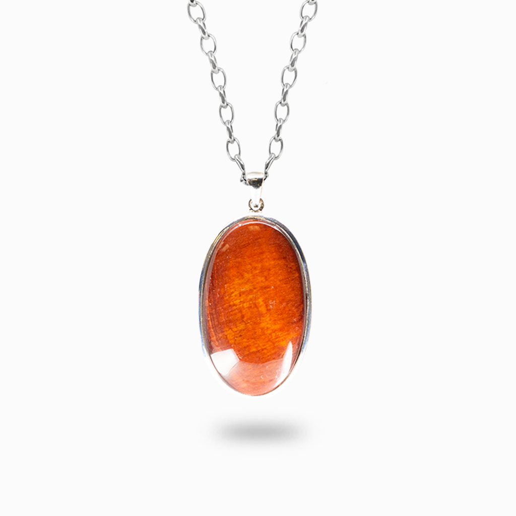 Oval Red Tiger Eye pendant necklace with rich copper-red color and silky reflective bands in a polished sterling silver bezel setting.