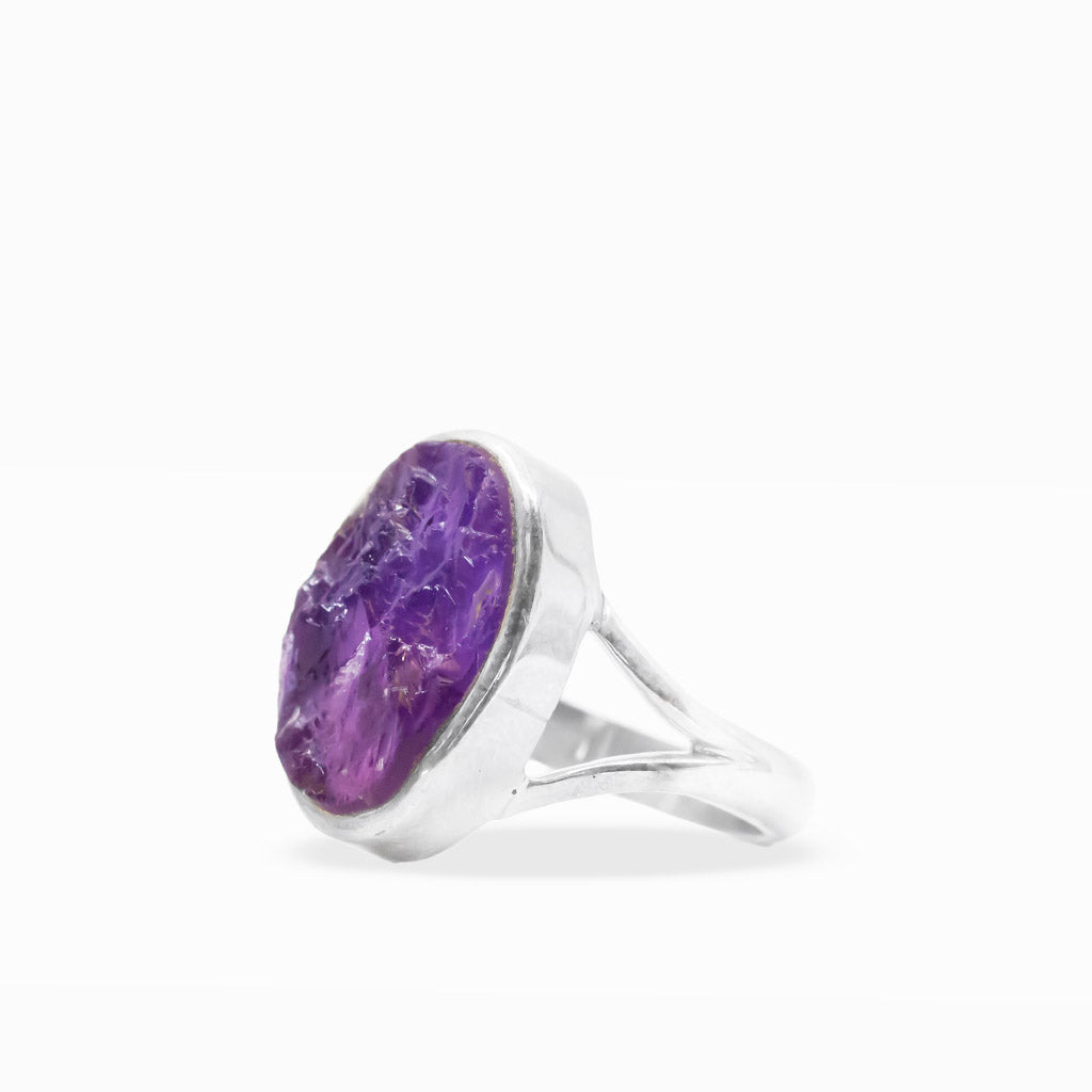 Raw purple Amethyst oval ring with natural crystalline inclusions, sterling silver bezel setting, and open split band.