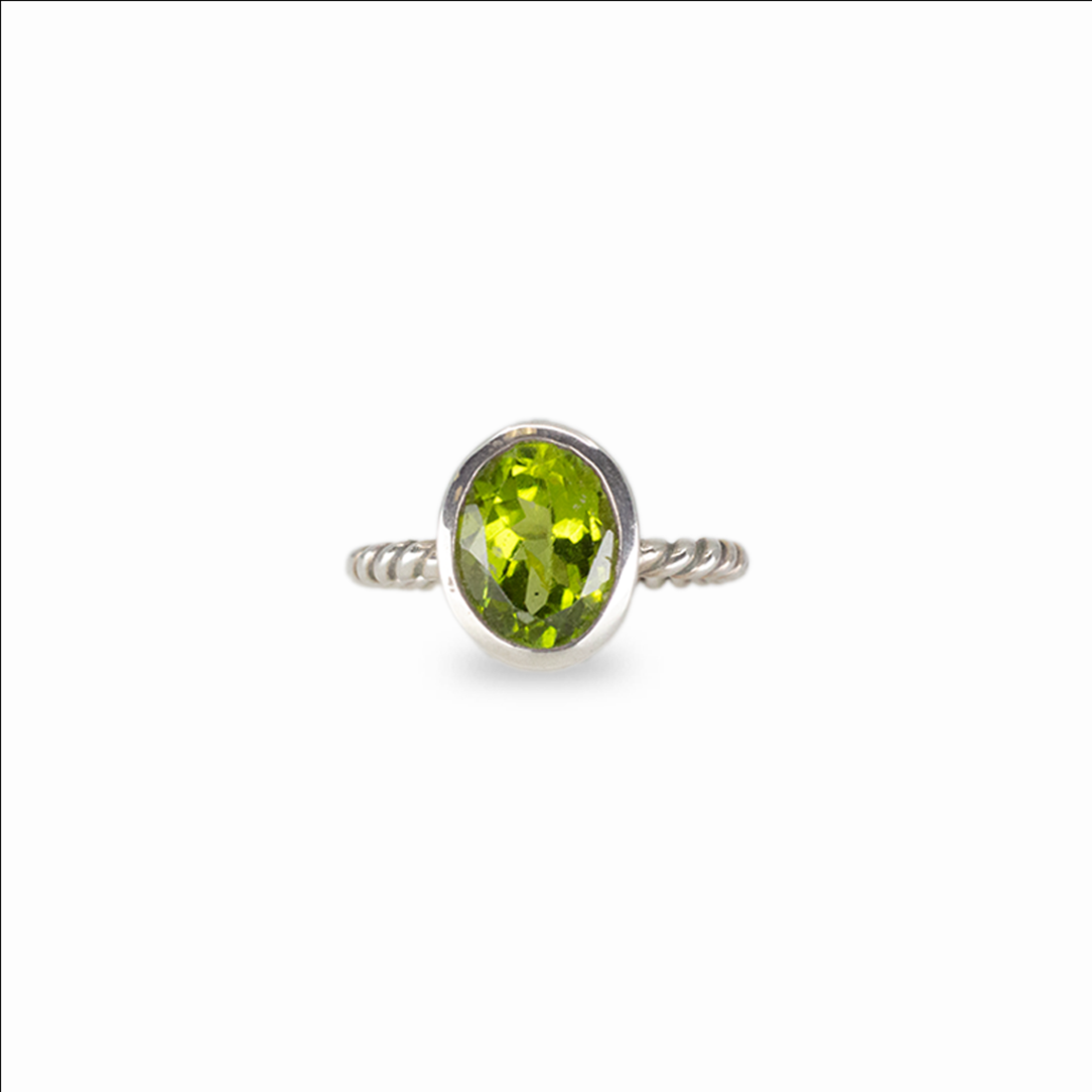 Oval peridot gemstone ring in sterling silver with vivid green color and minimalist stacking design