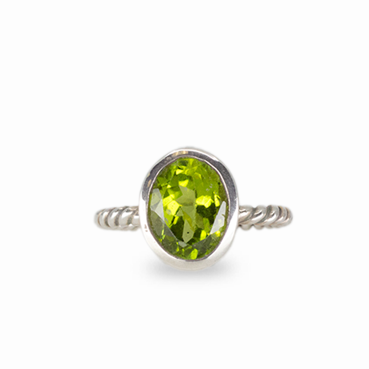 Oval peridot gemstone ring in sterling silver with vivid green color and minimalist stacking design