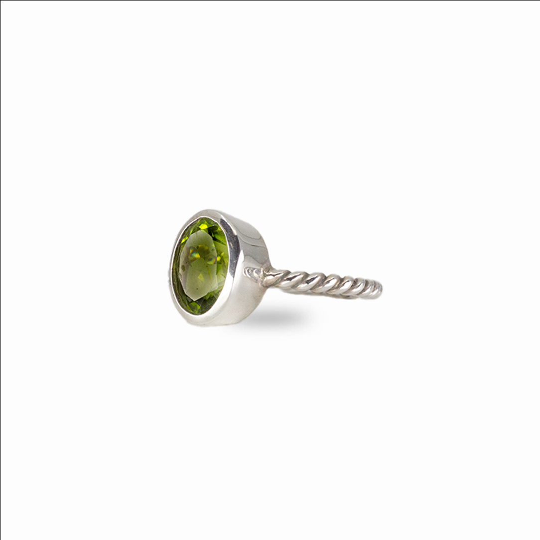 Oval peridot gemstone ring in sterling silver with vivid green color and minimalist stacking design