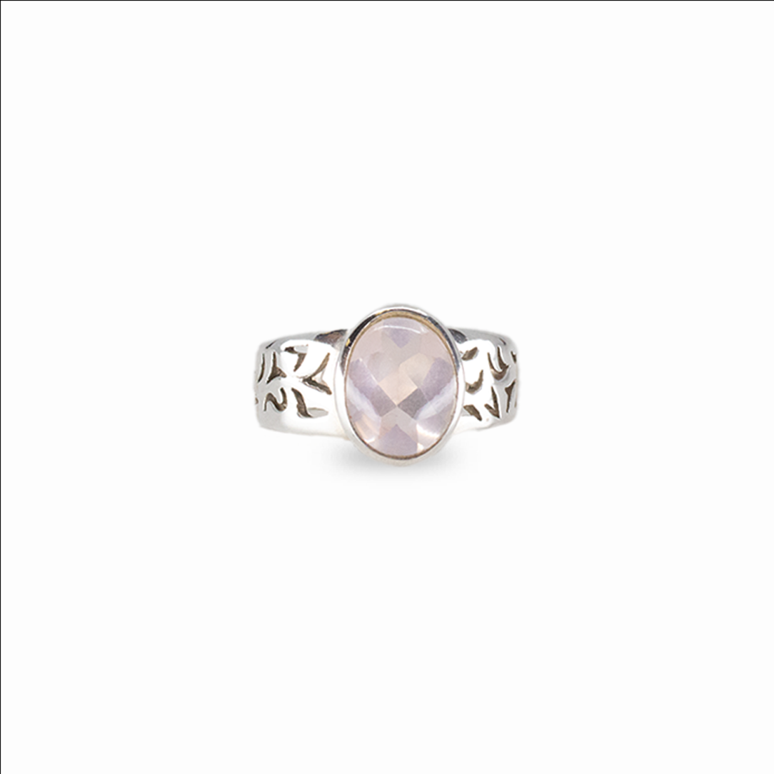 Oval rose quartz gemstone ring in sterling silver with soft pink faceted stone on white background