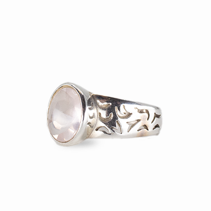 Oval rose quartz gemstone ring in sterling silver with soft pink faceted stone on white background