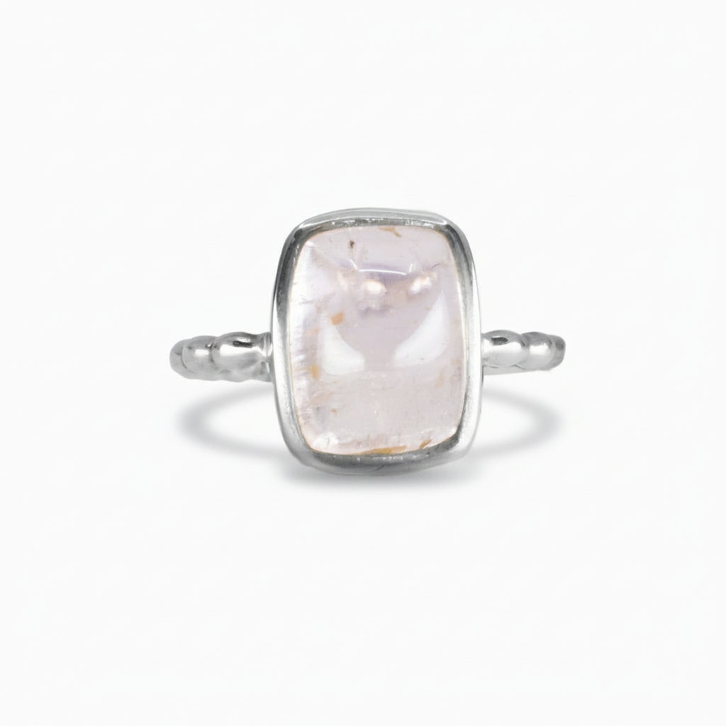 Rectangular soft pink Kunzite cabochon ring set in a polished sterling silver band with subtle texture, shown on a white background.| MADE IN EARTH