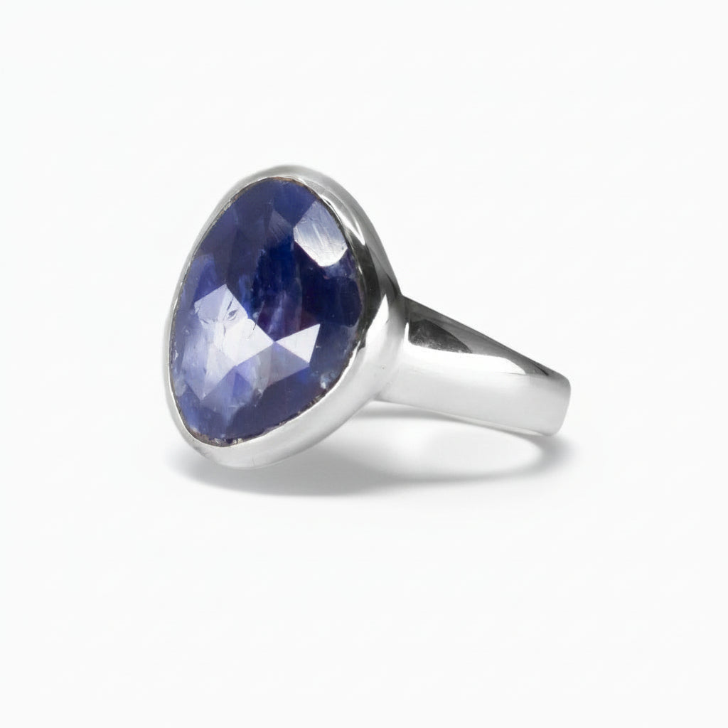 Faceted freeform deep blue Sapphire ring set in polished sterling silver, showing natural internal texture on a white background. | MADE IN EARTH