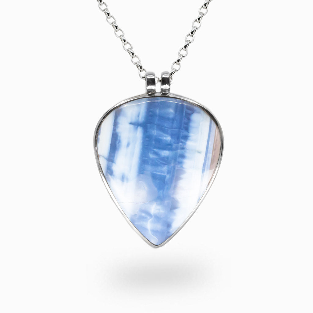 Teardrop-shaped Blue Opal pendant with soft blue and white banding set in polished sterling silver on a chain.| MADE IN EARTH