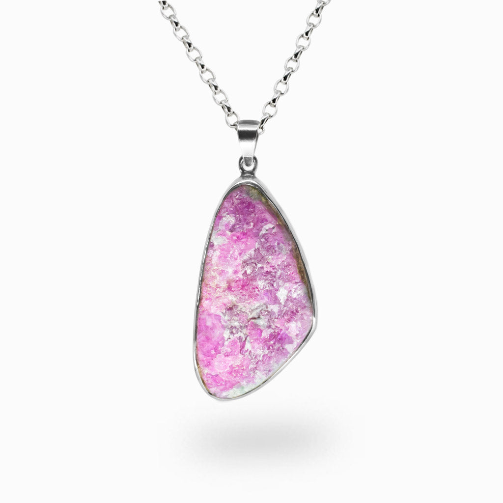 Organic raw Ruby pendant featuring vivid magenta-red crystal formations set in polished sterling silver on a chain. | MADE IN EARTH