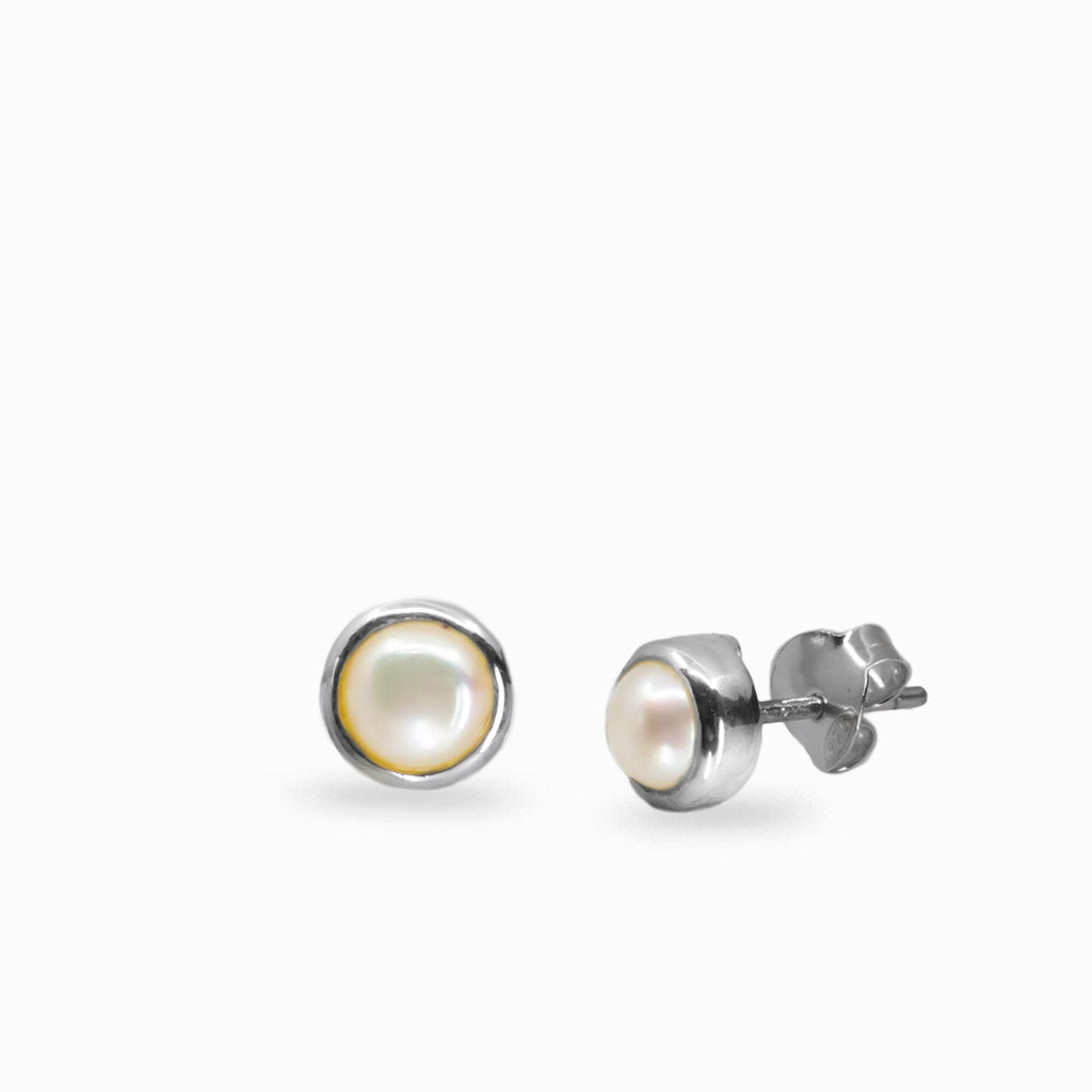 Pair of pearl stud earrings on a white background