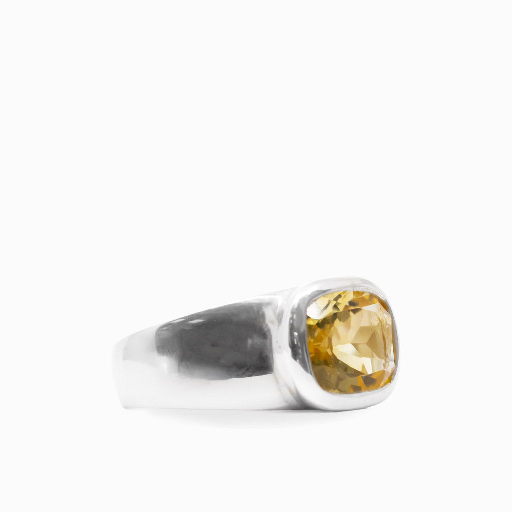 Cushion-shaped faceted golden Citrine gemstone set in a polished 925 sterling silver ring.