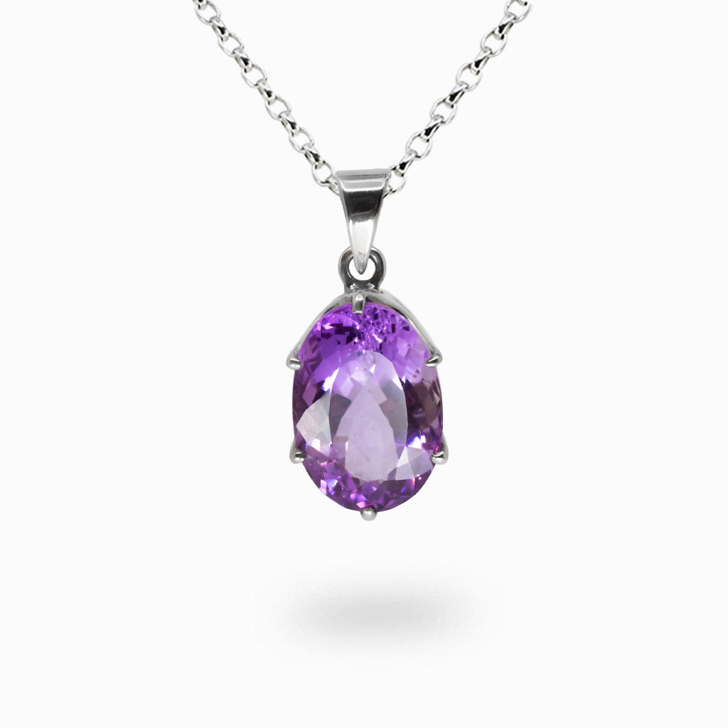 Faceted amethyst oval necklace in sterling silver, featuring vibrant purple gemstone with brilliant light-reflecting facets. |MADE IN EARTH