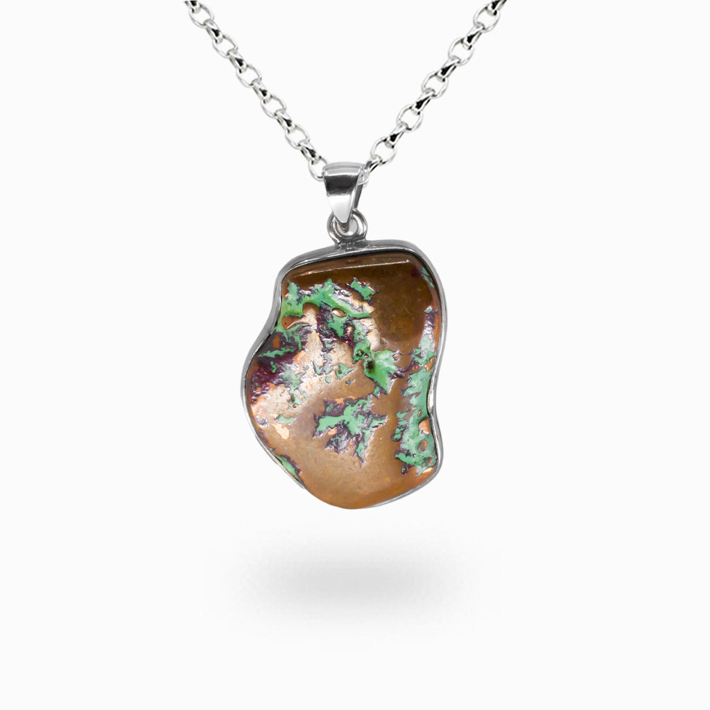 Raw copper freeform pendant with green oxidized patina and partial polish, set in sterling silver bezel on silver chain.| MADE IN EARTH
