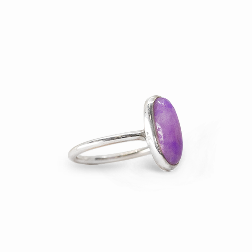Elongated oval purple Sugilite cabochon ring in polished 925 sterling silver with a smooth bezel setting and slender band.