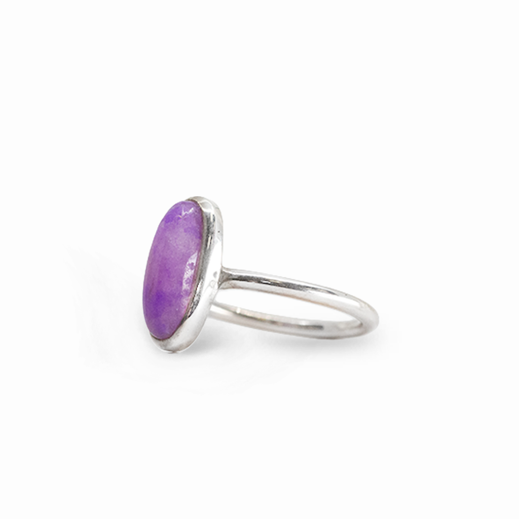 Elongated oval purple Sugilite cabochon ring in polished 925 sterling silver with a smooth bezel setting and slender band.