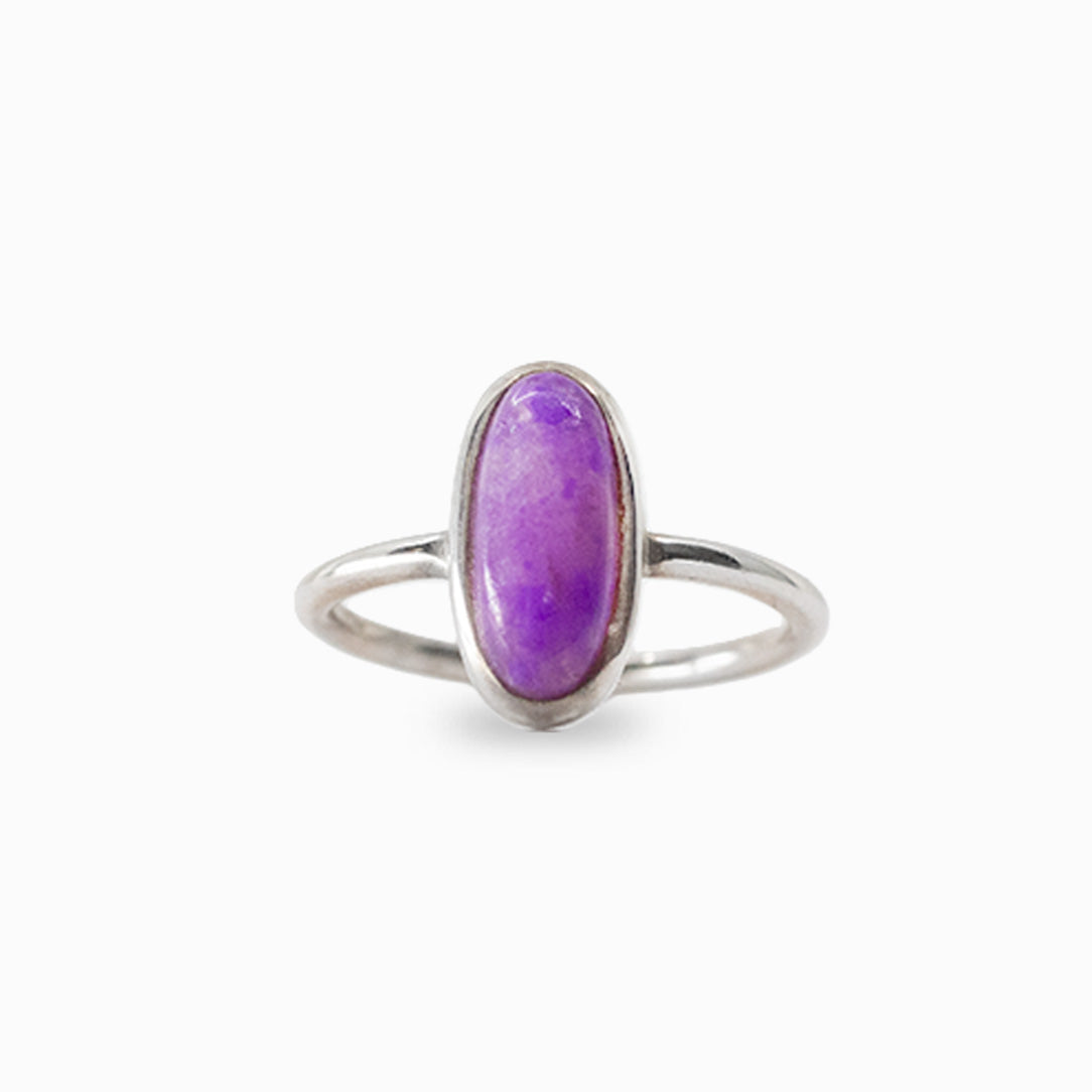 Elongated oval purple Sugilite cabochon ring in polished 925 sterling silver with a smooth bezel setting and slender band.