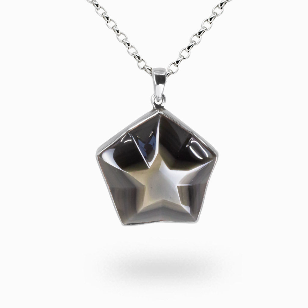 Star-shaped rainbow obsidian cabochon necklace in sterling silver bezel with iridescent volcanic glass and natural multicolor sheen. | MADE IN EARTH