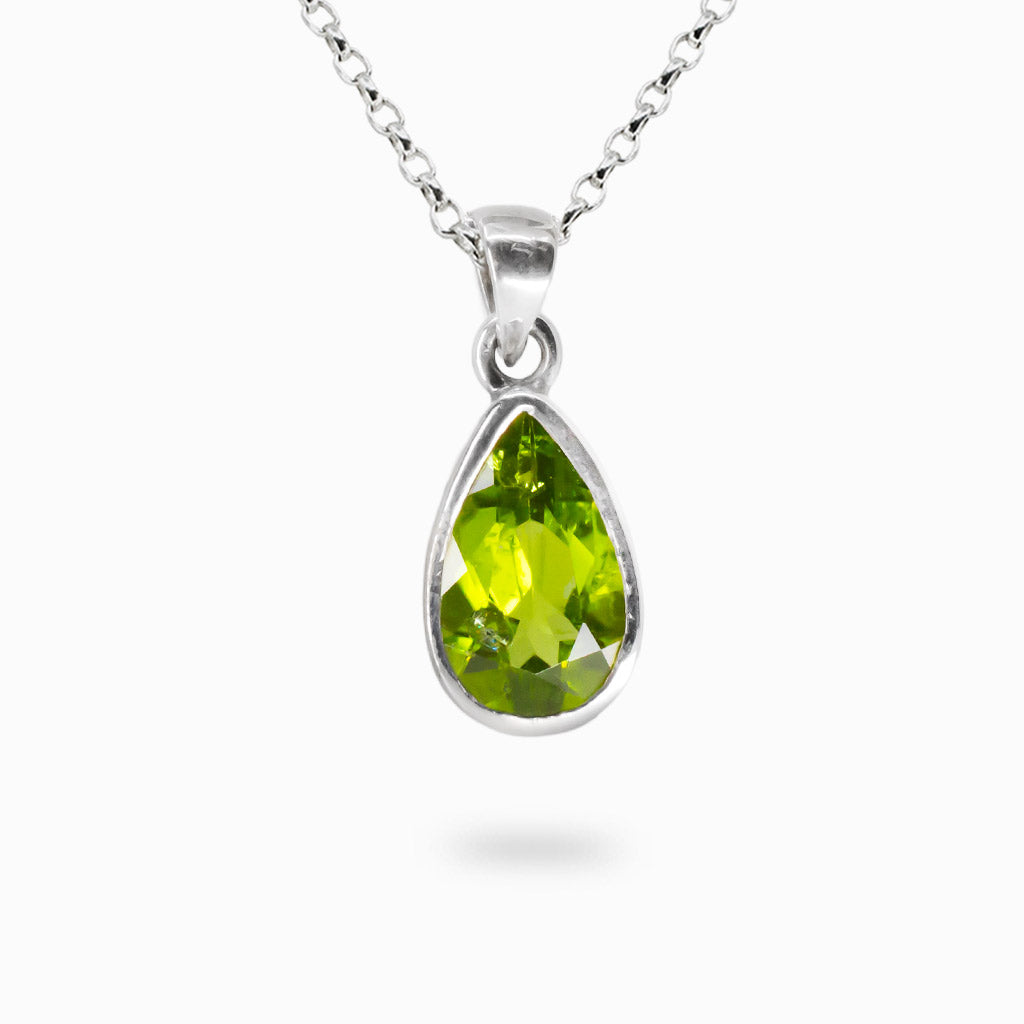 Faceted green Peridot tear gemstone necklace set in sterling silver bezel. MADE IN EARTH