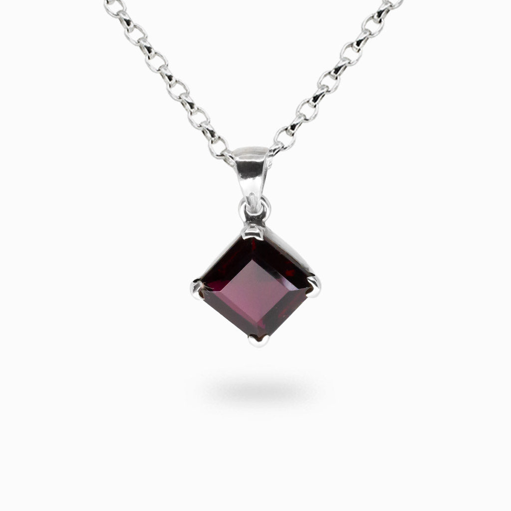 Faceted garnet diamond-shaped pendant necklace in sterling silver setting. MADE IN EARTH