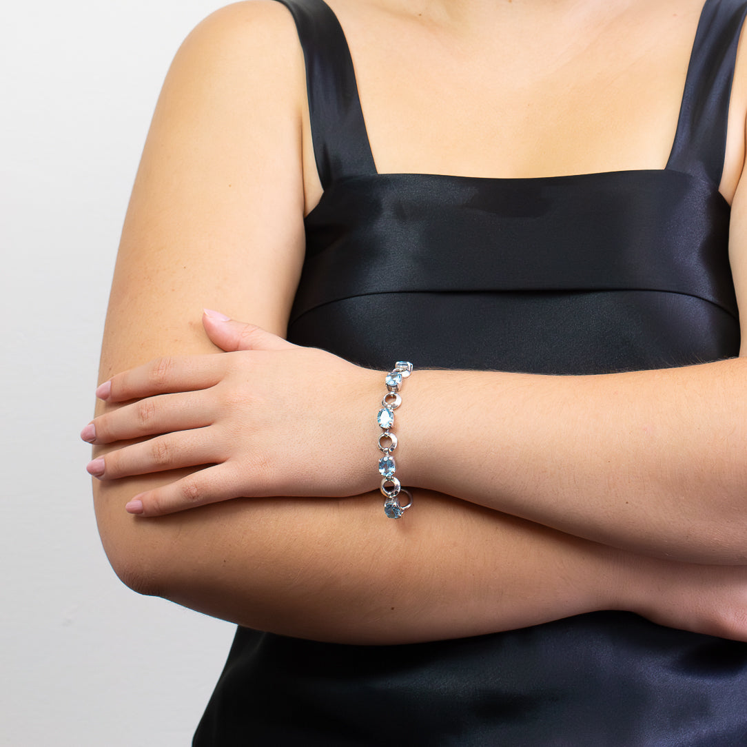 Blue Topaz sterling silver link bracelet with faceted oval gemstones.