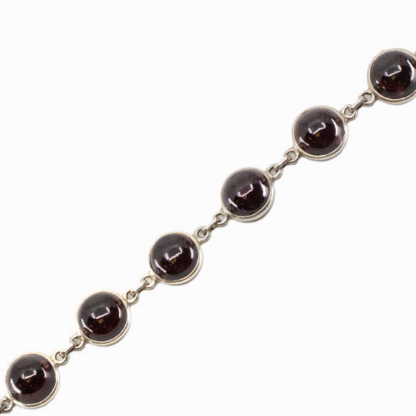 Sterling silver Garnet bracelet featuring faceted deep red gemstones with elegant sparkle and timeless design.