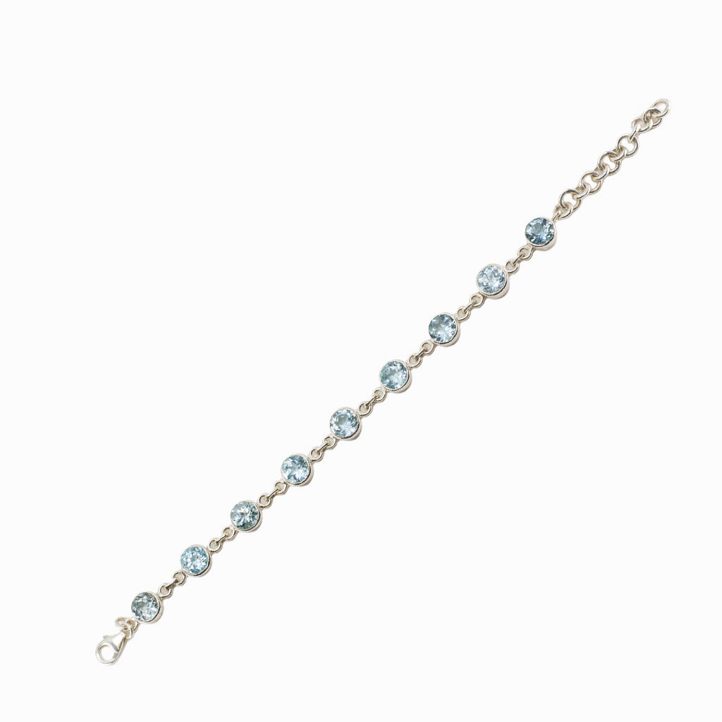 Faceted Blue Topaz bracelet in sterling silver with round blue gemstones.