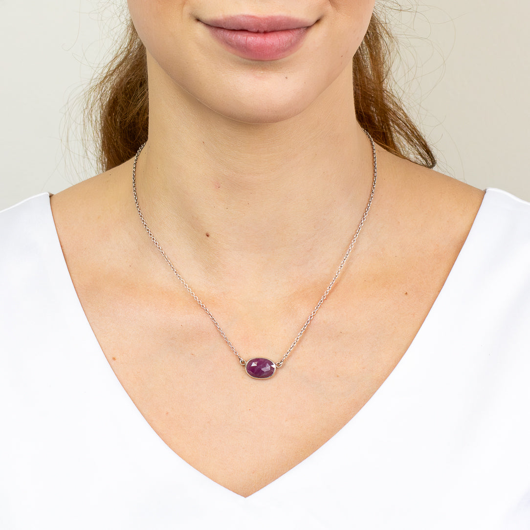Faceted oval Ruby necklace in sterling silver bezel setting.