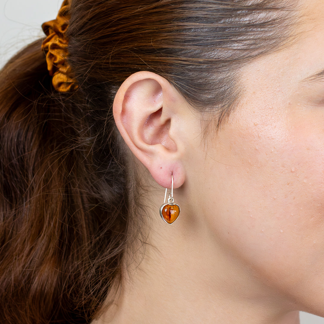 Heart shaped amber drop earrings in sterling silver ON MODEL