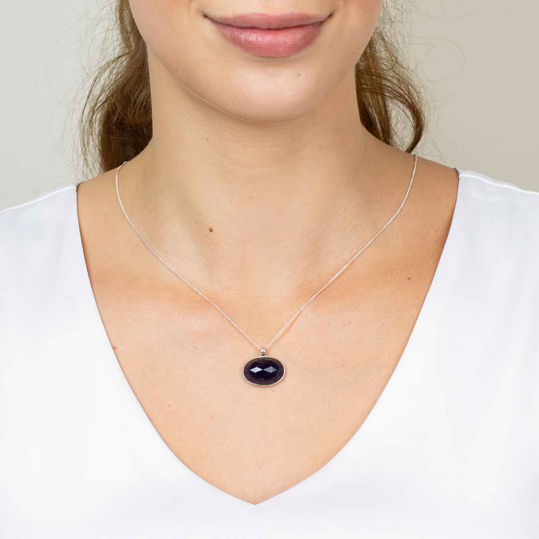 Faceted oval iolite necklace in sterling silver ON MODEL