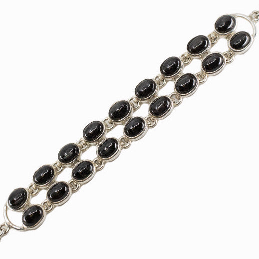 Black Star Diopside bracelet in sterling silver with polished black oval gemstones.