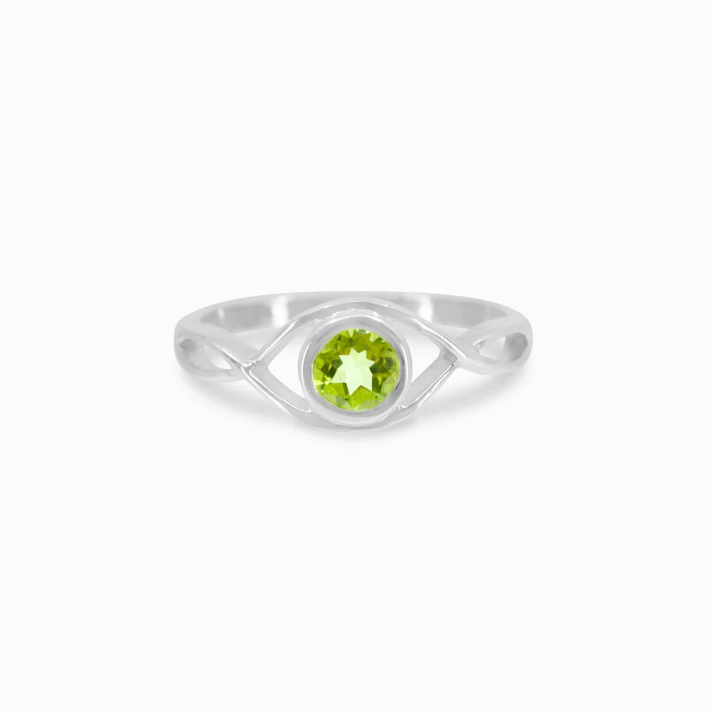 Round faceted green Peridot gemstone in polished sterling silver eye design ring.