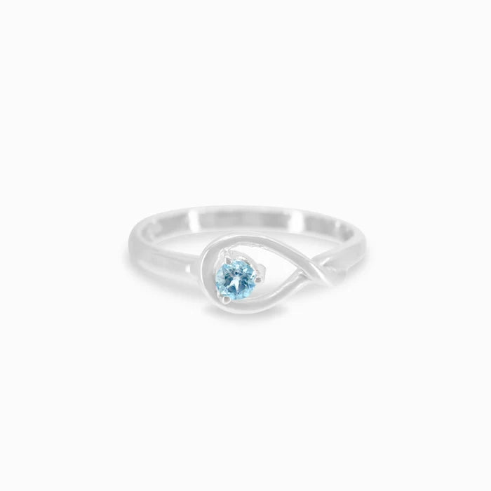 Round faceted Blue Topaz gemstone prong set in polished sterling silver ring.