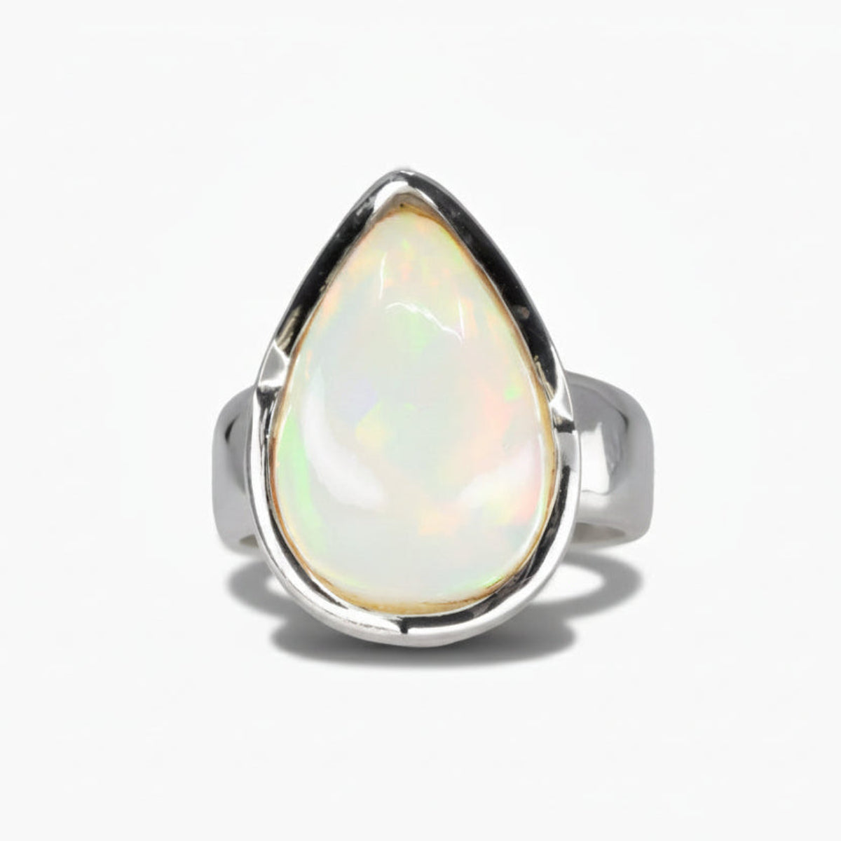 Tear shaped precious opal cabochon ring set in sterling silver with iridescent gemstone. MADE IN EARTH
