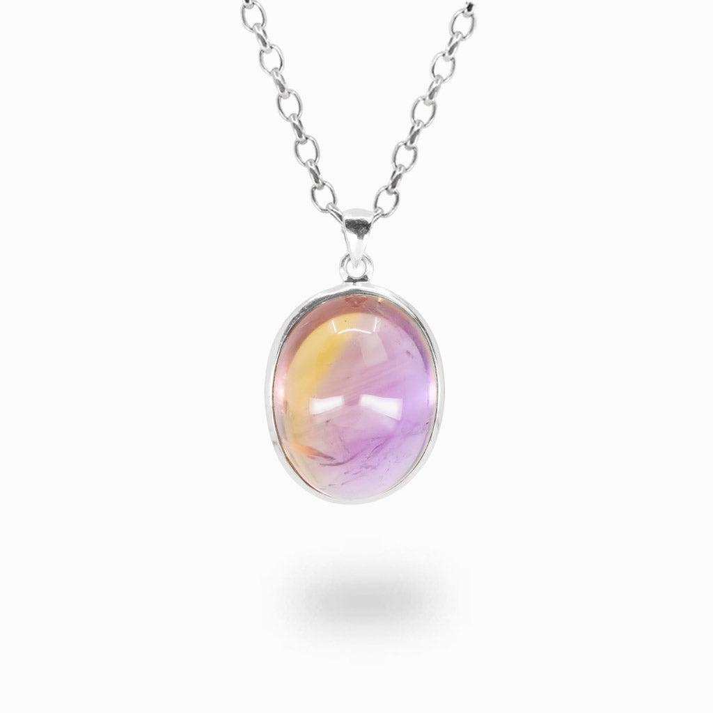 Oval cabochon Ametrine pendant necklace in sterling silver displaying natural golden and purple color zoning.