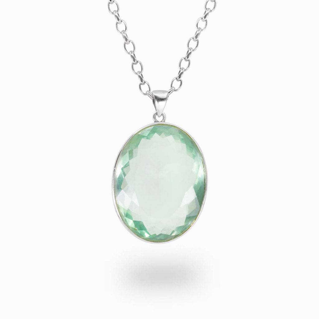 Faceted oval Fluorite pendant necklace in sterling silver featuring a translucent pale green gemstone on a silver chain.