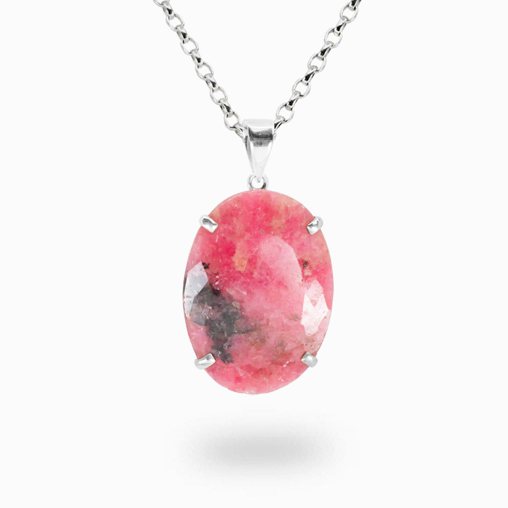 Faceted oval Rhodonite pendant necklace in sterling silver showcasing natural pink and black coloration.