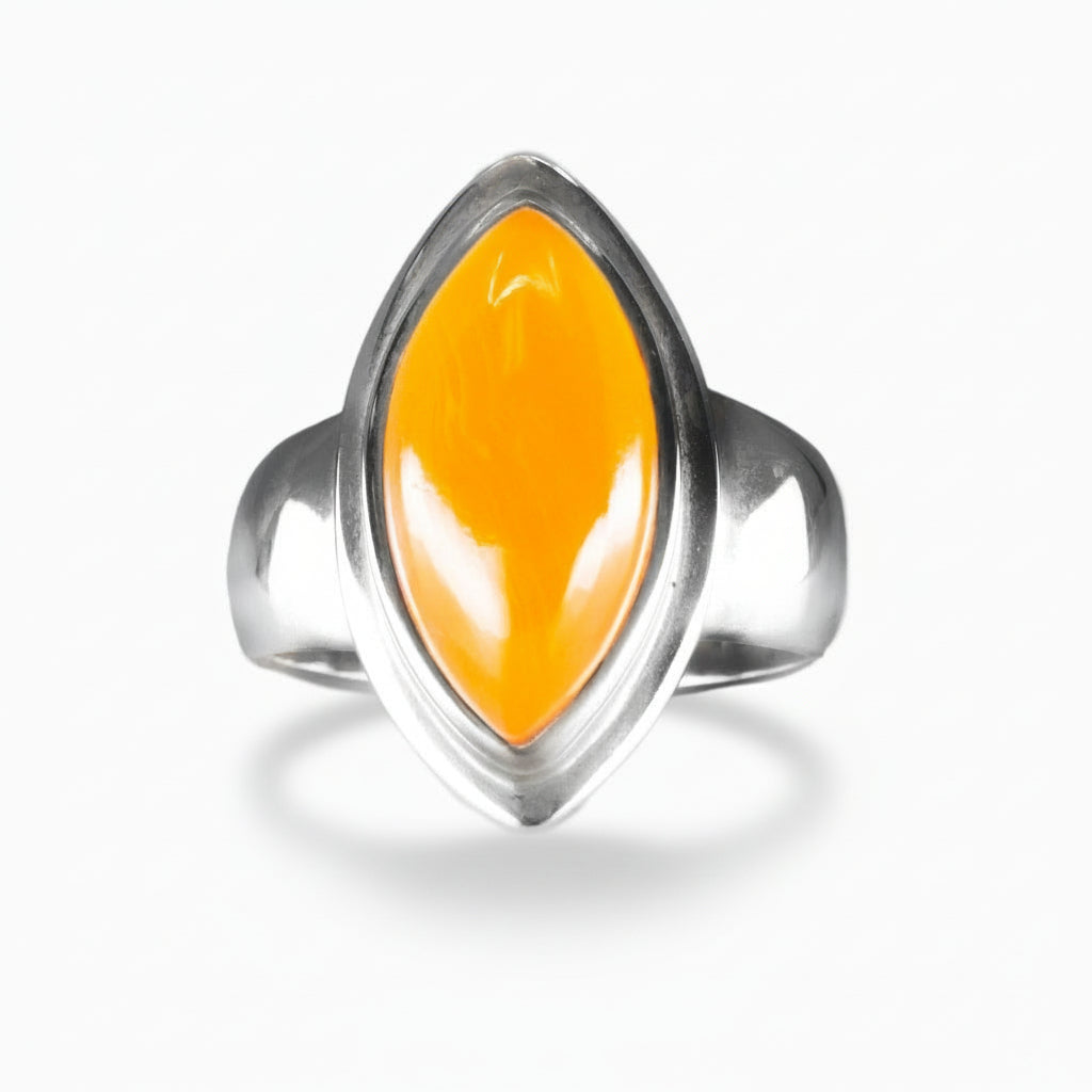 Marquise-cut orange Carnelian cabochon ring set in polished sterling silver with smooth, modern contours on a white background. | MADE IN EARTH