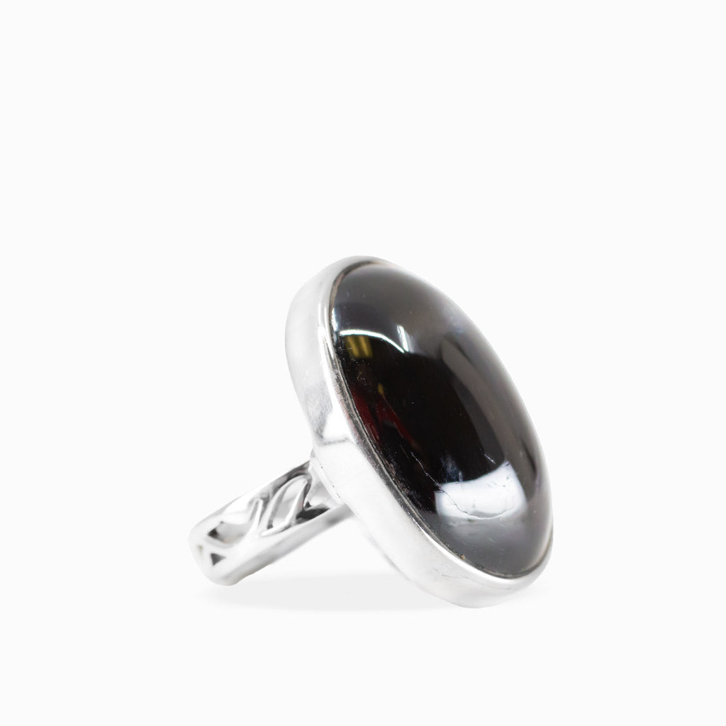 Oval Black Star Diopside ring with glossy black cabochon gemstone and polished 925 sterling silver bezel setting.