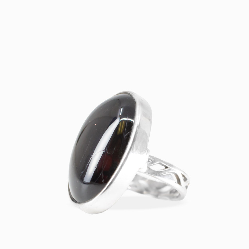Oval Black Star Diopside ring with glossy black cabochon gemstone and polished 925 sterling silver bezel setting.