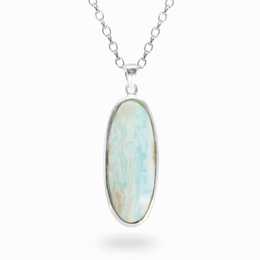 Elongated oval Caribbean Calcite pendant with pale blue, white and beige swirling patterns in polished 925 sterling silver.
