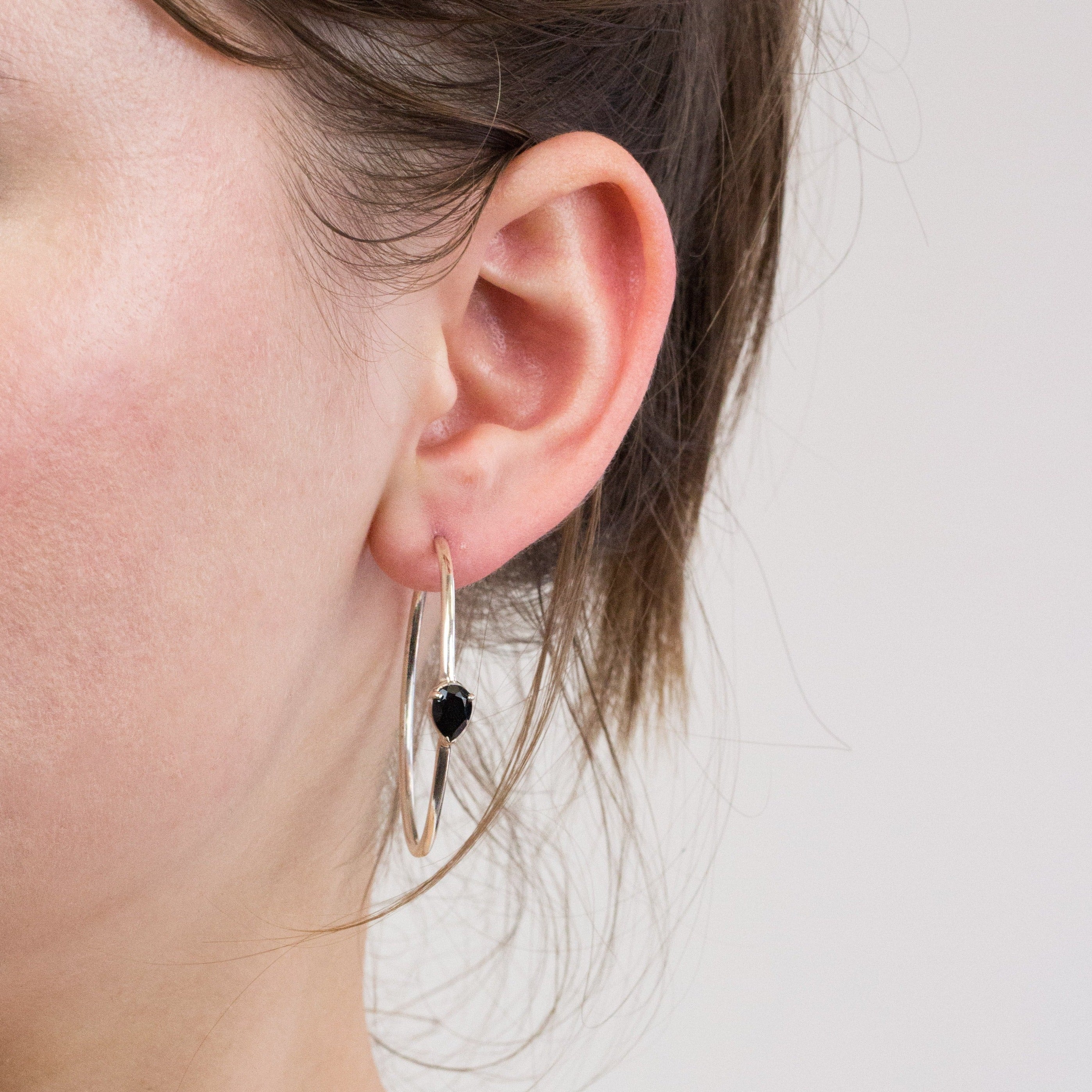 Onyx hoop earrings on model