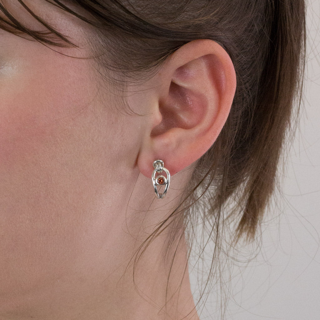 Garnet stud earrings on model