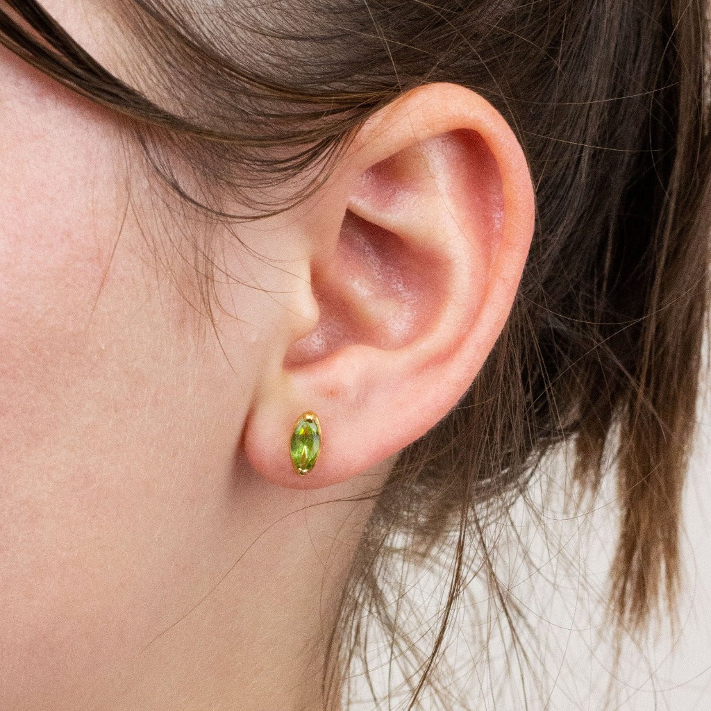 Peridot stud earrings on model