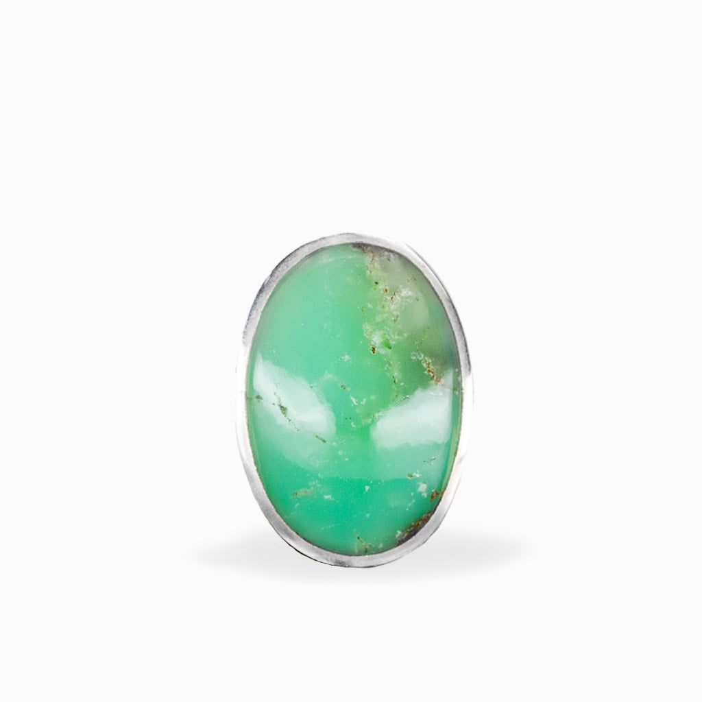 Oval Chrysoprase ring with vibrant apple-green cabochon, subtle natural inclusions, and polished sterling silver bezel setting.