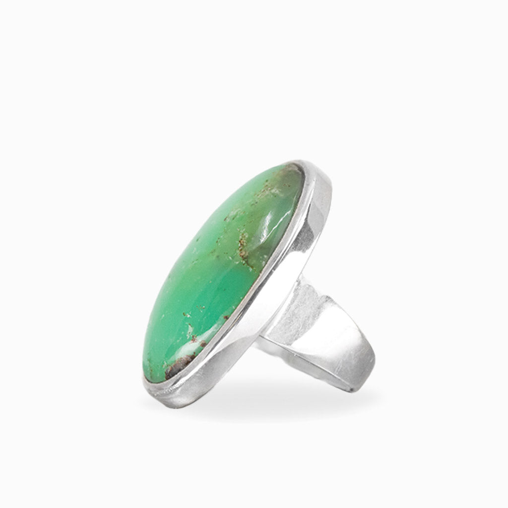 Oval Chrysoprase ring with vibrant apple-green cabochon, subtle natural inclusions, and polished sterling silver bezel setting.