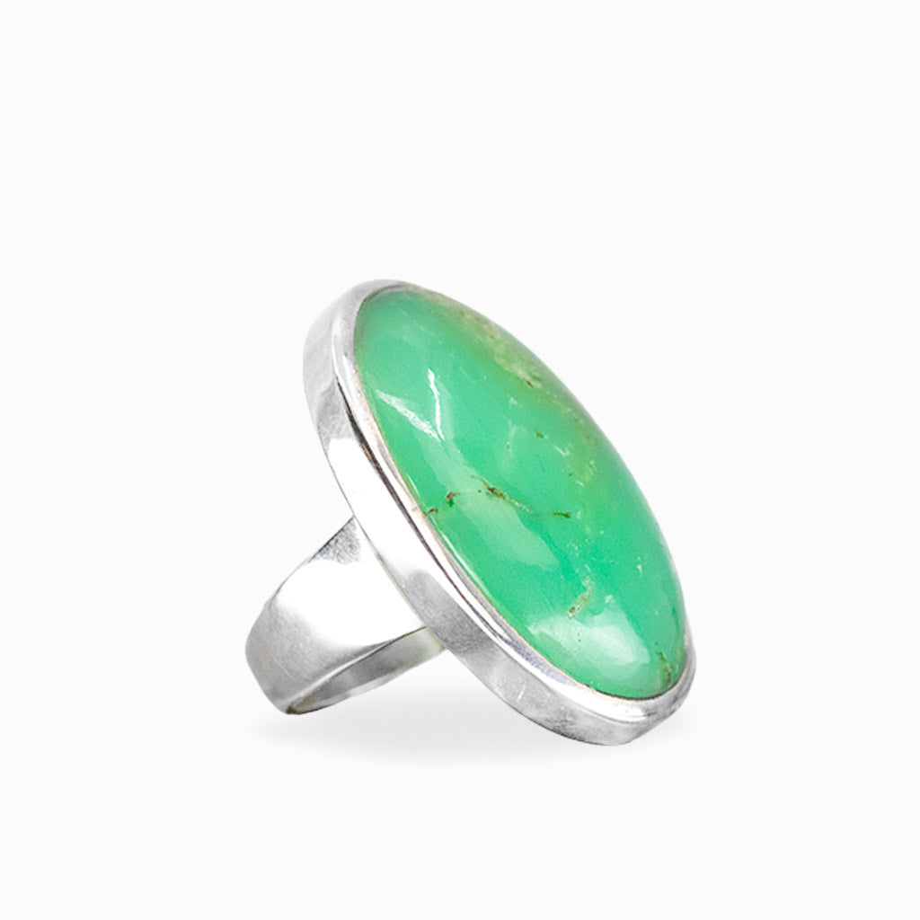 Oval Chrysoprase ring with vibrant apple-green cabochon, subtle natural inclusions, and polished sterling silver bezel setting.