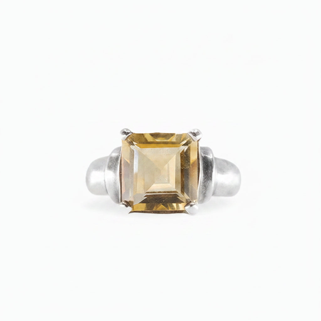 Rectangular faceted Citrine ring in polished 925 sterling silver with a warm golden-yellow gemstone and prong setting.