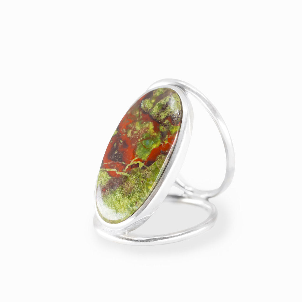 Oval Dragon's Blood Jasper ring with forest-green and crimson-red natural patterns, polished sterling silver bezel, and openwork band.
