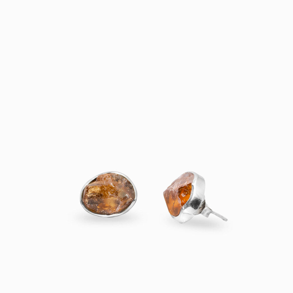 Sterling silver stud earrings featuring natural raw Grossular Garnet gemstones in organic bezel settings.
